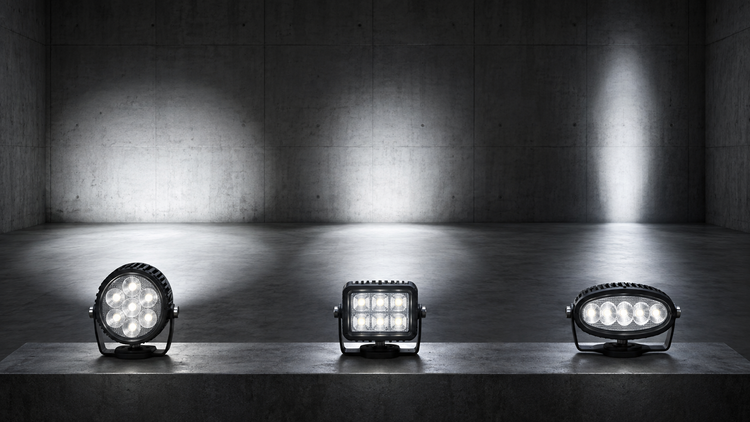 Original editorial illustration of three generic LED work lamps projecting different beam patterns in a test room